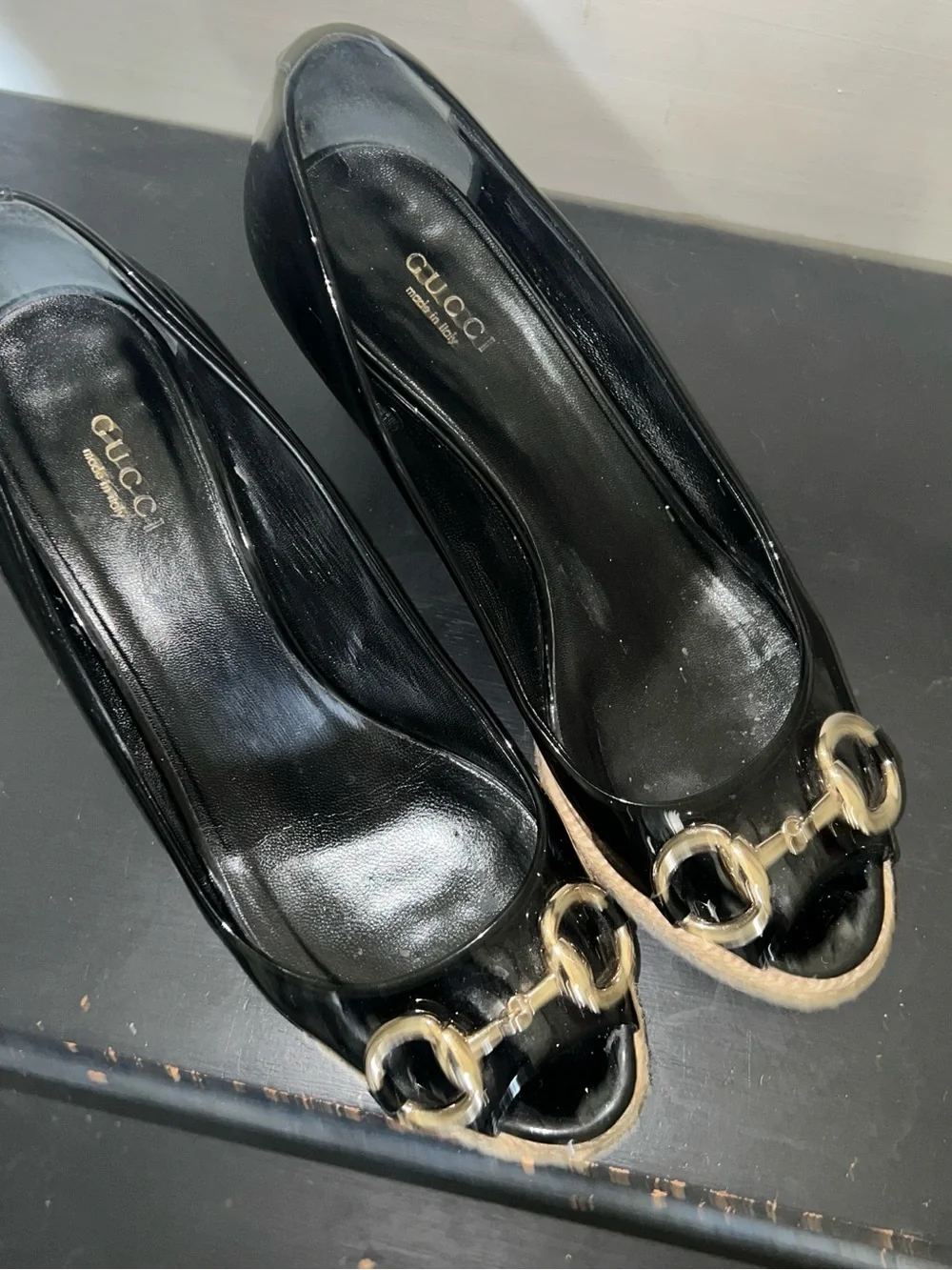 Black patent leather Gucci wedges with horsebit and peep toe